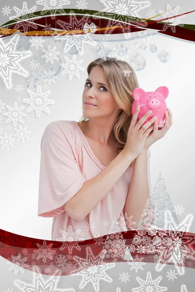 Vrouw met een piggy bank tot haar hoofd — Stockfoto