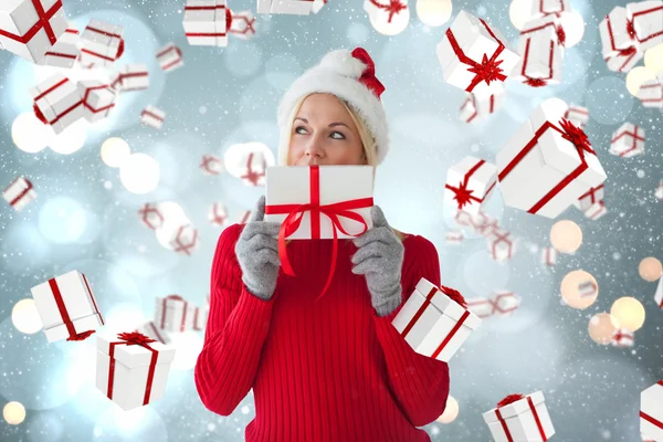 Composite image of happy festive blonde with gift — Stock Photo, Image