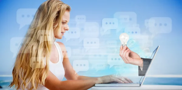 Blonde using her laptop at the beach — Stock Photo, Image