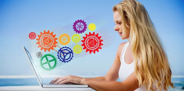 Blonde using her laptop at the beach — Stock Photo, Image