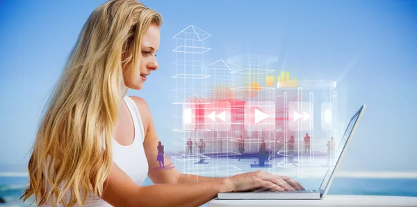 Blonde using her laptop at the beach — Stock Photo, Image