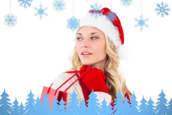 Festive blonde holding shopping bags — Stock Photo, Image