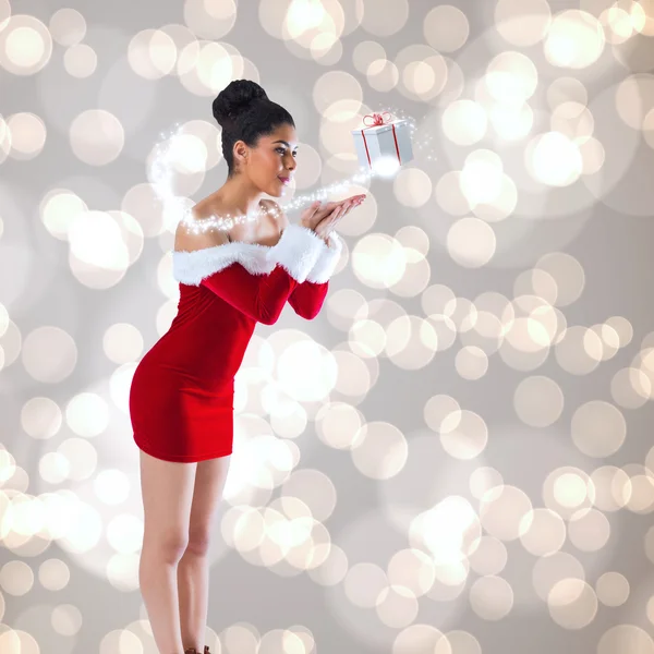 Santa girl blowing over her hands — Stock Photo, Image