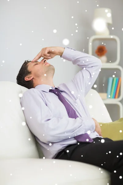 Tired businessman sitting on sofa — Stock Photo, Image