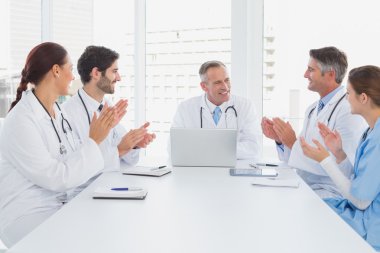 Doctors applauding a fellow doctor clipart