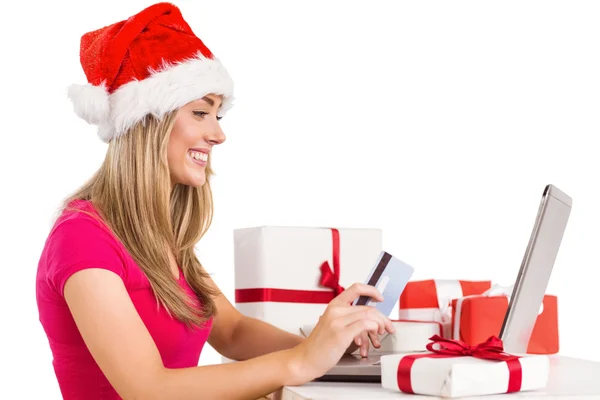 Festive blonde shopping online with laptop — Stock Photo, Image