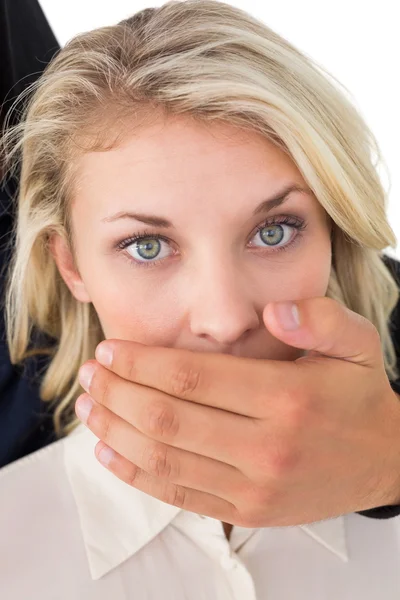 Hand covering young woman's mouth — Stock Photo, Image