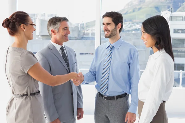 Two fellow employees shaking hands — Stock Photo, Image