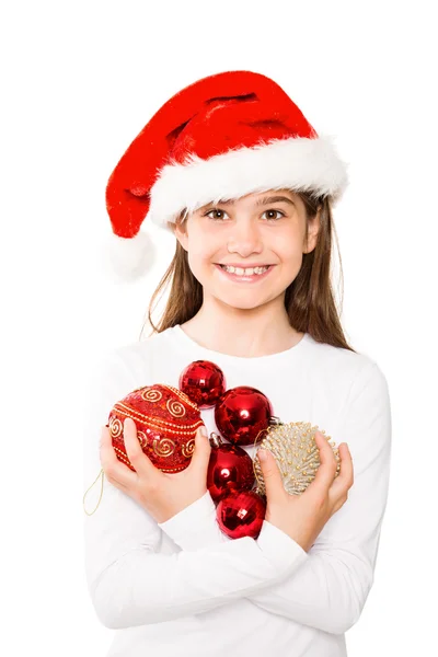 Niña festiva sonriendo a la cámara sosteniendo bolas — Foto de Stock