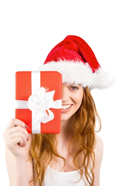 Festive redhead holding a gift — Stock Photo, Image