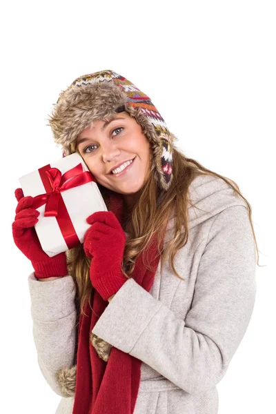 Happy blonde in winter clothes holding gift — Stock Photo, Image