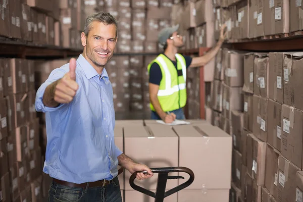 Warehouse manager with trolley — Stock Photo, Image
