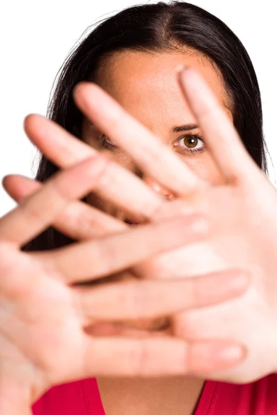 Young brunette hiding behind hands — Stock Photo, Image