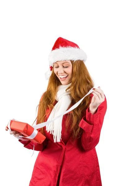 Festive redhead holding pile of gifts — Stock Photo, Image