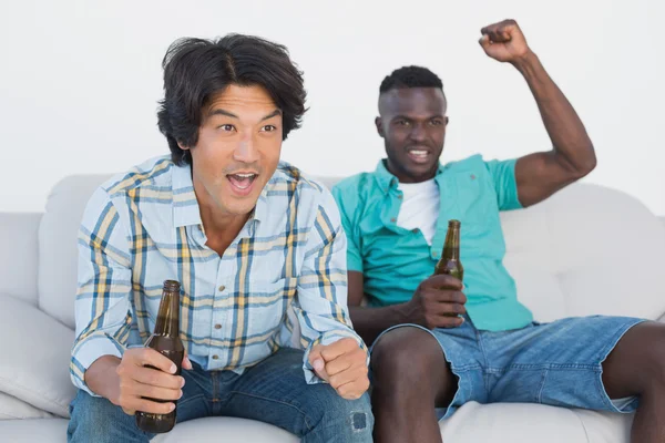 Soccer fans cheering while watching tv — Stock Photo, Image