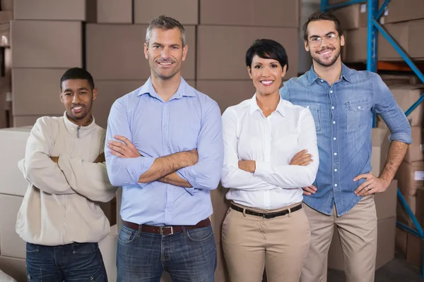 Warehouse workers smiling at camera — Stock Photo, Image