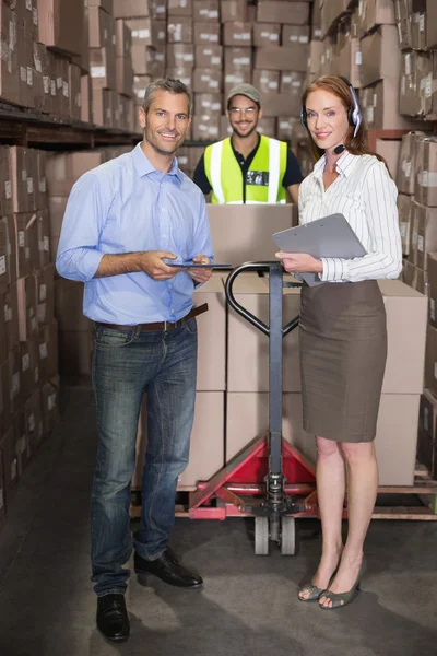 Warehouse team smiling at camera — Stock Photo, Image