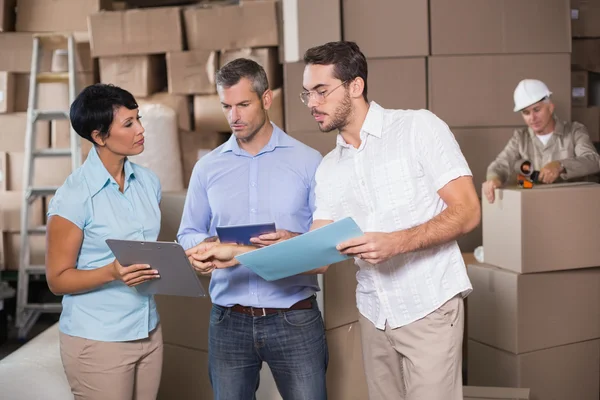 Warehouse workers talking together at work — Stock Photo, Image