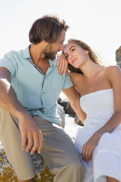 Gorgeous couple embracing at the coast — Stock Photo, Image