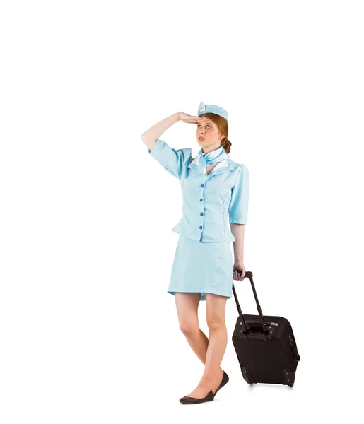 Pretty air hostess pulling suitcase — Stock Photo, Image