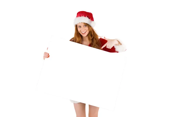 Festive redhead smiling at camera holding poster — Stock Photo, Image