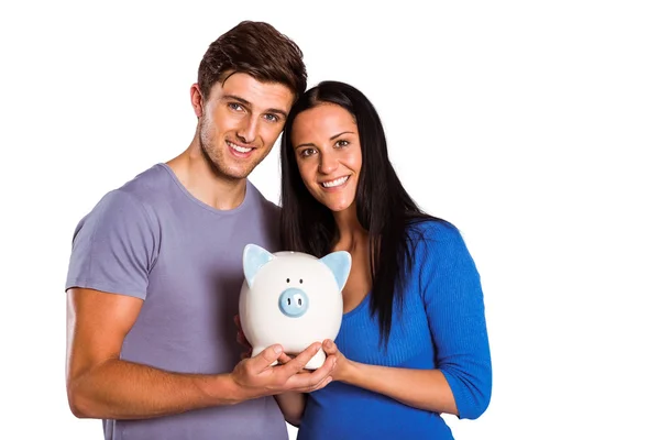 Young couple holding a piggy bank — Stock Photo, Image