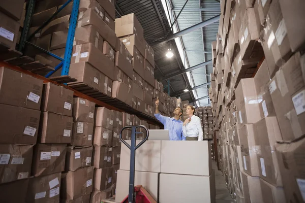 Warehouse team working together with trolley — Stock Photo, Image