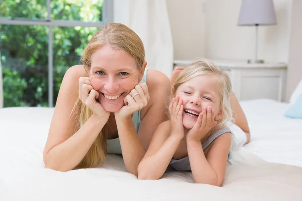 Girl and mother on bed — Stock Photo, Image