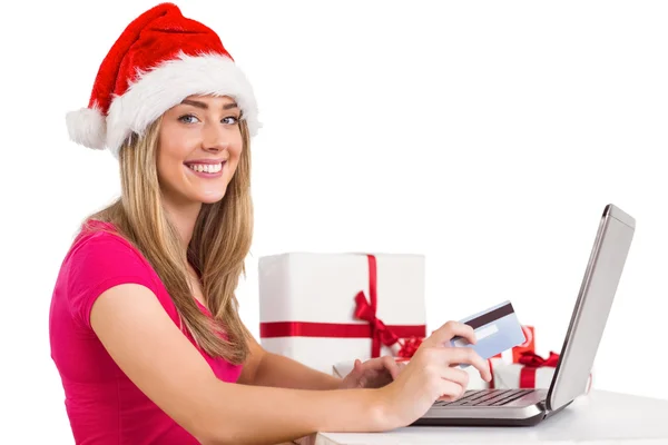 Festive blonde shopping online with laptop — Stock Photo, Image