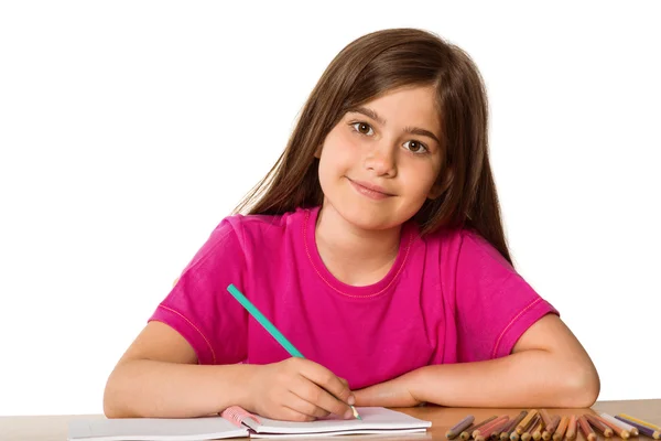 Cute pupil working at her desk Royalty Free Stock Photos