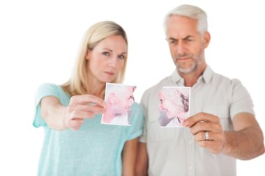 Couple holding two halves of torn photograph clipart
