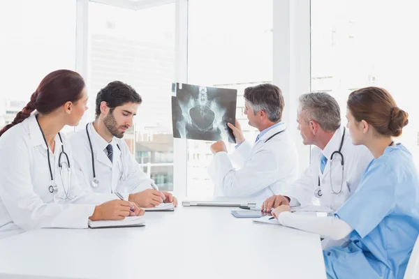 Doctor holding up an x-ray — Stock Photo, Image