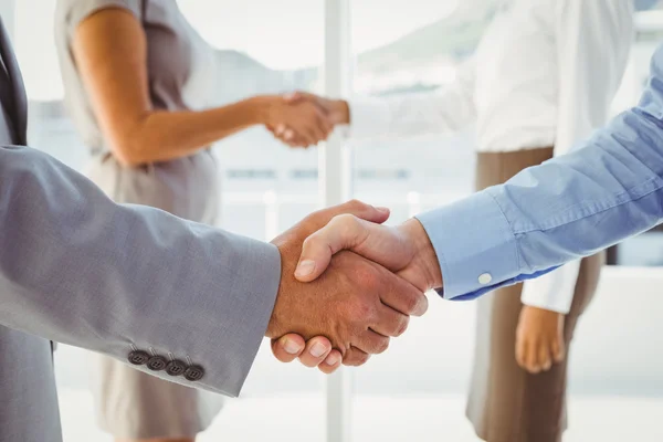 Two fellow employees shaking hands — Stock Photo, Image