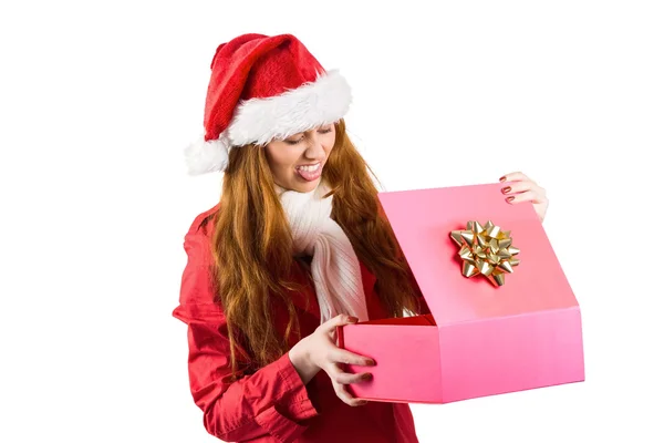 Festive redhead opening a gift — Stock Photo, Image