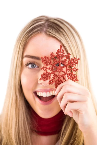 Happy blonde holding red snowflake — Stock Photo, Image