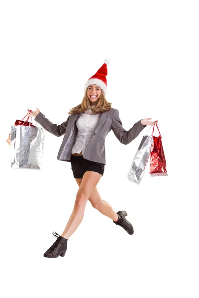 Festive blonde jumping with shopping bags — Stock Photo, Image