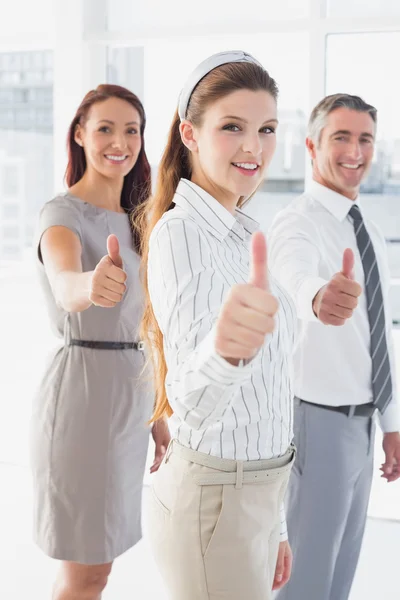 Smiling businesswoman giving thumbs up — Stock Photo, Image