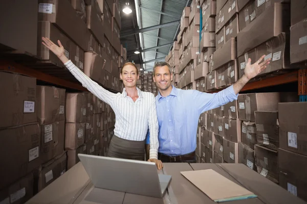 Warehouse team working together on laptop — Stock Photo, Image