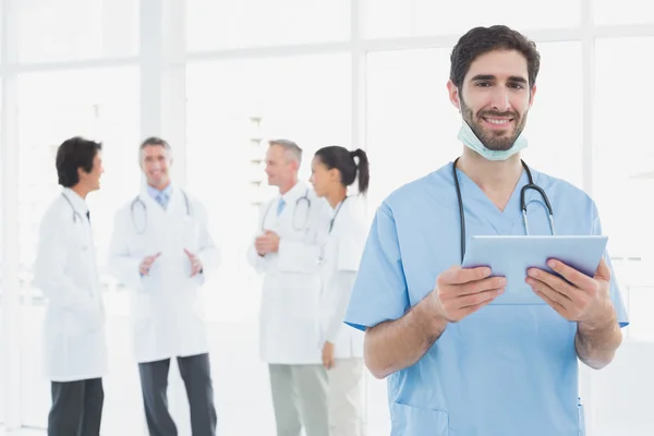 Médico sorridente com um comprimido — Fotografia de Stock