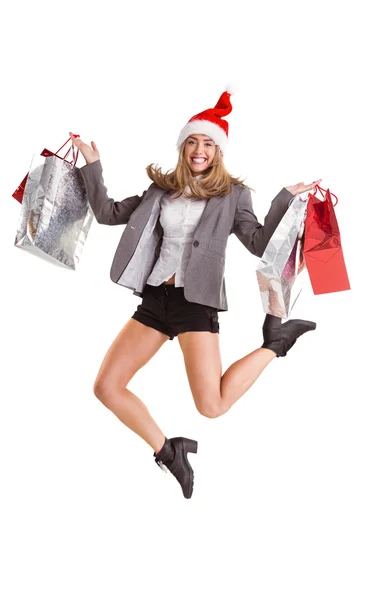 Festive blonde jumping with shopping bags — Stock Photo, Image