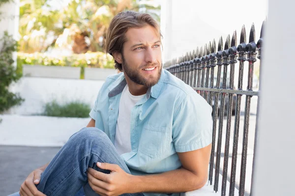 Casual man sitting and thinking — Stock Photo, Image