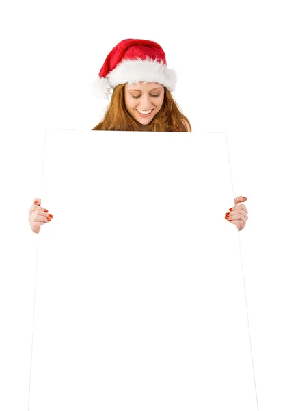 Festive redhead smiling at camera holding poster — Stock Photo, Image