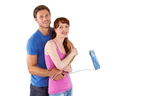 Couple hugging and holding brush — Stock Photo, Image