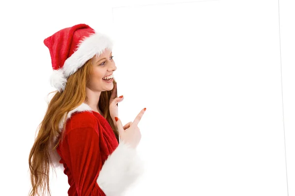 Festive redhead smiling at camera holding poster — Stock Photo, Image