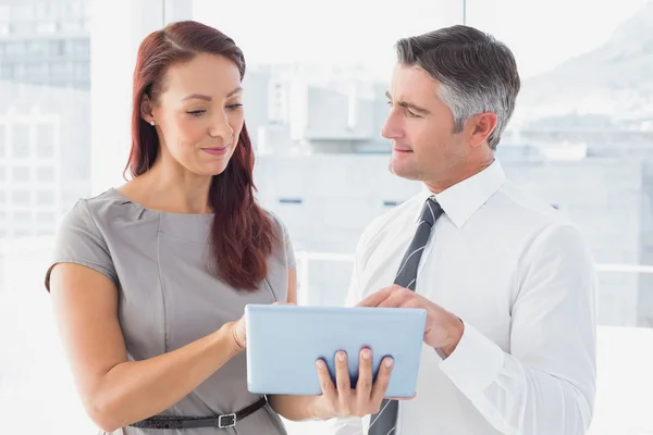 Business people holding a tablet — Stock Photo, Image