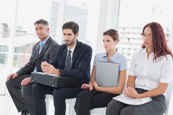 Serious business people sitting together — Stock Photo, Image