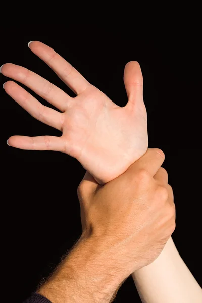 Womans wrist held by man — Stock Photo, Image