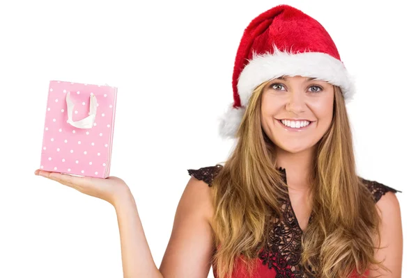 Festive blonde holding a gift bag — Stock Photo, Image