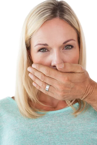 Hand covering young woman's mouth — Stock Photo, Image