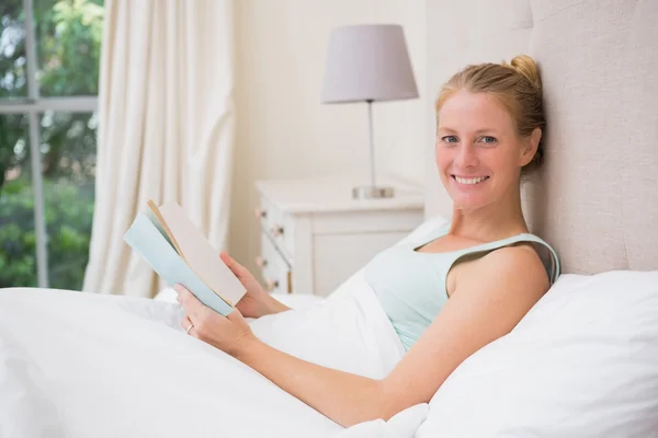 Happy blonde reading her book — Stock Photo, Image